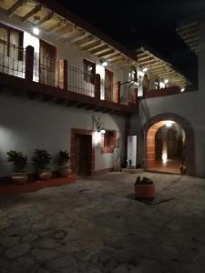 a building with a courtyard with potted plants at Hotel Hacienda Encantada in Real de Catorce