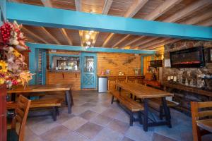 a dining room with wooden tables and a bar at Ouray Inn in Ouray
