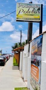 a sign for a pueblo polling station next to a sidewalk at Pousada Poleto's in Bertioga