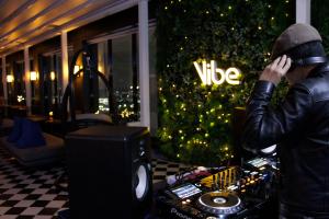 a man talking on a cell phone in front of a christmas tree at Hotel Alice and Trunk in Jeju