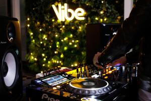 a dj mixing music in front of a christmas tree at Hotel Alice and Trunk in Jeju