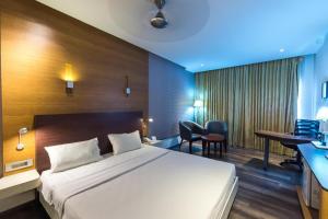 Säng eller sängar i ett rum på Hotel Indraprastha