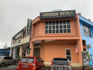 a building with cars parked in front of it at SPOT ON 90144 Corridor Hotel 1 in Pekan