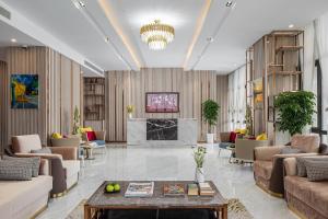 a lobby with couches and a table and a fireplace at Sensory Park Urban Hotel in Phnom Penh