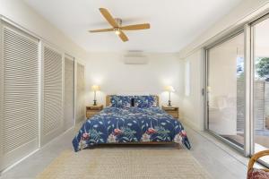 A bed or beds in a room at The Cove Noosa