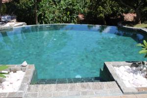 a large swimming pool with blue water at The Spice House Mirissa in Mirissa