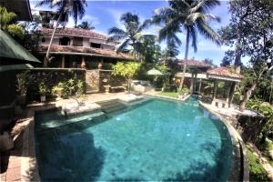 an image of a swimming pool in front of a house at The Spice House Mirissa in Mirissa