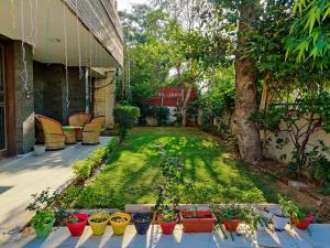 a garden with potted plants on a patio at Hoztel Jaipur in Jaipur