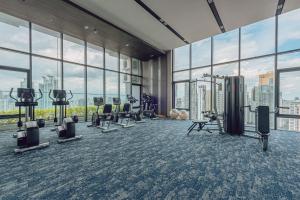 a gym with a view of a city at Siamese Exclusive Queens in Bangkok