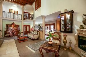 a large living room filled with furniture and a fireplace at Misty Waves Boutique Hotel in Hermanus