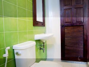 a bathroom with a toilet and a sink and a mirror at Ivory Phi Phi Island in Phi Phi Don