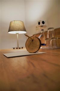 a lamp sitting on a table next to ainylinylinylinylinylinylinyl at Maiers Hotel Parsberg in Parsberg