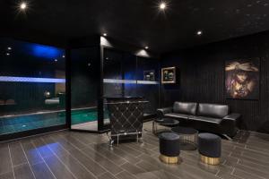 a living room with a couch and a pool at H Hotel & SPA - Adults Only in St. Julianʼs