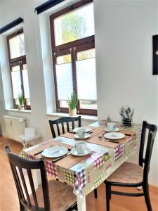 a dining room table with a table cloth on it at Citywohnung am Rannischen Platz I in Halle an der Saale