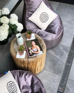 a coffee table with a picture of a girl on it at moser-HOCHKÖNIG Genuss Wirtshaus Hotel in Maria Alm am Steinernen Meer