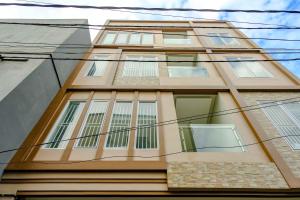 a tall building with lots of windows on it at RedDoorz near Pasar Baru 3 in Jakarta