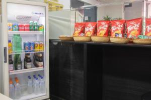 a refrigerator filled with drinks and bottles of soda at Mangabeiras Hotel in Goiânia