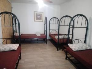 a room with four iron bunk beds in it at Fourways Guest Lodge in Johannesburg +30 photos