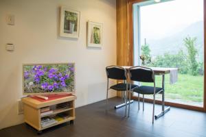 a room with a table and two chairs and a window at Hüsmatta (Michael Gschwendtner) in Fieschertal