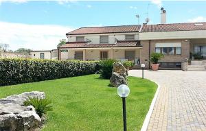 a house with a lawn with two lights in front of it at Villa Genny in Altamura