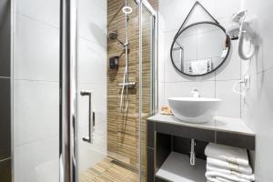 a bathroom with a sink, toilet and shower stall at Weranda Apartments in Morzyczyn