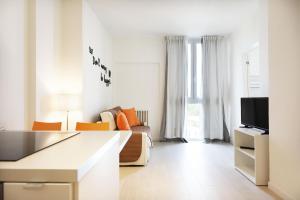 a white living room with a couch and a tv at Yourbanflat Eremitani in Padova