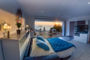 a bedroom with a large bed and a view of the ocean at Vistazur Luxueux appartement avec terrasse et piscine in Rayol-Canadel-sur-Mer