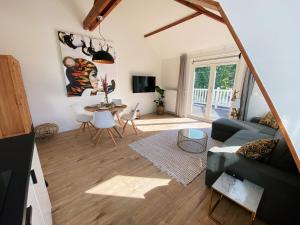 een woonkamer met een bank en een tafel bij Luxurious historical Loft close to the beach!! in Wassenaar