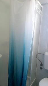 baño con ducha con cortina azul en One bedroom apartement with sea view enclosed garden and wifi at Zadar 3 km away from the beach, en Zadar
