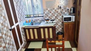 a small kitchen with a sink and a microwave at One bedroom appartement with city view furnished terrace and wifi at Souillac in Souillac