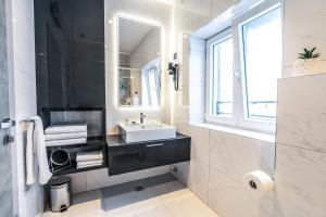 a bathroom with a sink and a mirror at Calma LUXURY Rooms in Split +142 photos