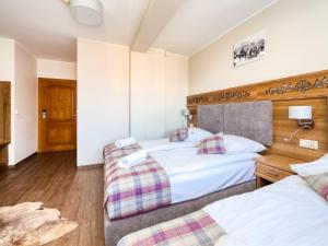 a hotel room with two beds and a couch at Dom Wypoczynkowy U Chramca in Białka Tatrzańska +96 photos