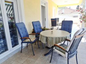 a table and chairs sitting on a patio at Apartments Nada in Starigrad-Paklenica