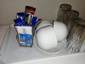 a shelf with a computer mouse and eggs and milk at Acorn Lodge & SKYDECK in Potchefstroom