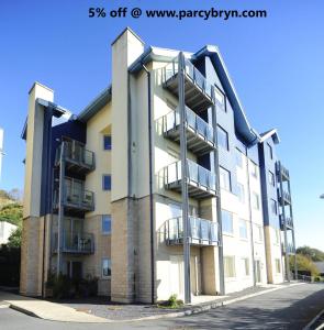 an apartment building with balconies on the side at Parc y Bryn Serviced Apartments in Aberystwyth