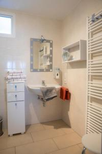 a white bathroom with a sink and a mirror at Niedersburger Eck, wandern, radfahren, genießen, erholen in Boppard