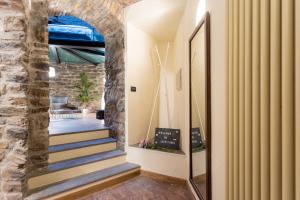 a hallway with stairs and a stone wall at Ice Queen Chamber by Rent All Como in Como +71 photos