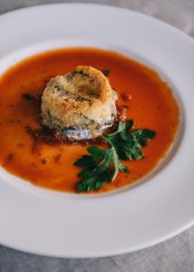 a bowl of soup with a piece of food in it at Mami Sabaudia Hotel in Sabaudia