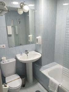 a bathroom with a sink and a toilet and a shower at Hotel Alda Estación Pontevedra in Pontevedra