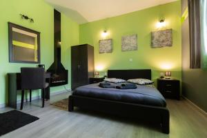 a bedroom with a bed and a table and a fireplace at La Terra Nostra in Korinthos