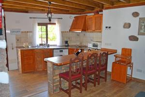 a kitchen with a wooden counter and a kitchen island at La casa de Tea in Santa Lucía
