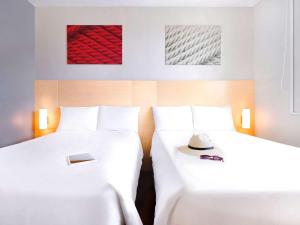 Cama ou camas em um quarto em Ibis Cancun Centro