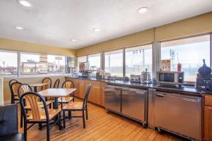 a kitchen with a table and chairs and a kitchen withwindows at Econo Lodge Clovis in Clovis
