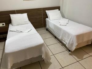 Кровать или кровати в номере Hotel Plaza Inn Flat Residence