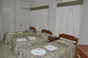 Кровать или кровати в номере Hotel Plaza Inn Flat Residence