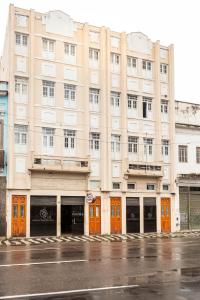 a large building with orange doors on a street at Pompeu Rio Hotel in Rio de Janeiro