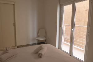 a bedroom with a bed and a large window at Sea View lo pagan in San Pedro del Pinatar