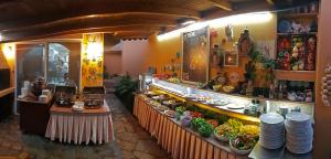 a restaurant with a counter with plates and food at Papirus Hotel in Adrasan