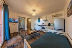 a large kitchen with a table and a refrigerator at Royal Palm in Porto-Vecchio