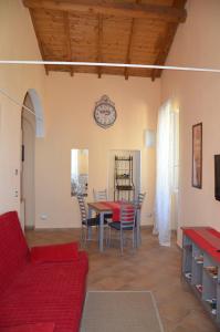 a living room with a table and chairs and a clock at Villa Mont des Oliviers CITRA-8055LT-1805 e 1807 in Sanremo